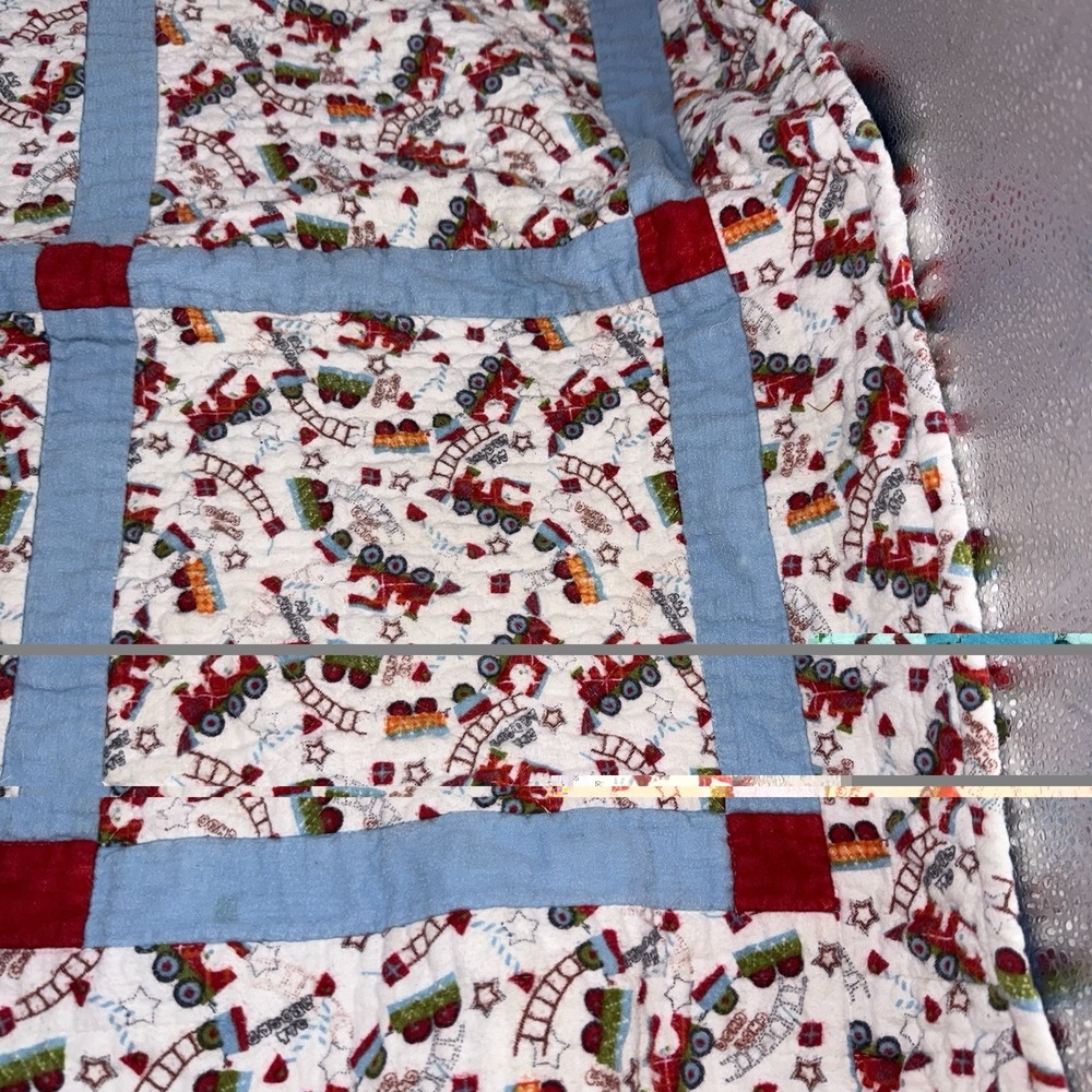 Vtg Baby Quilt Of Trains Print bordered by blue sashing and red cornerstones